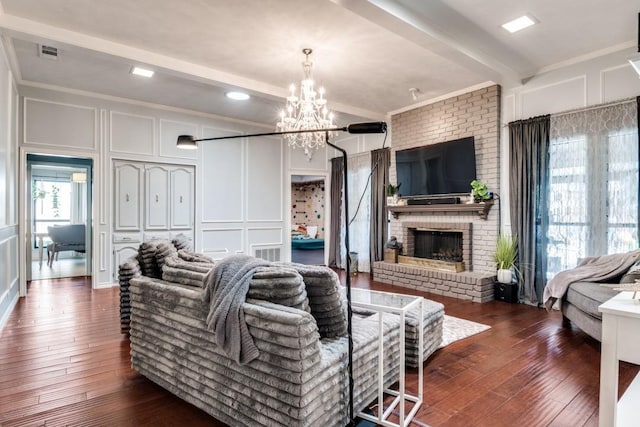 6211 White Rose Trl, Dallas, TX 75248 - living area featuring a decorative wall, crown molding, a chandelier, dark wood-style floors, and a brick fireplace