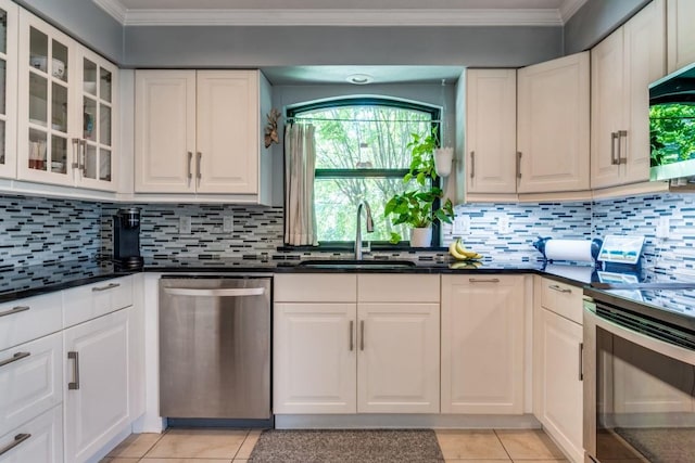 6211 White Rose Trl, Dallas, TX 75248 - kitchen featuring appliances with stainless steel finishes, ornamental molding, light tile patterned flooring, and white cabinetry
