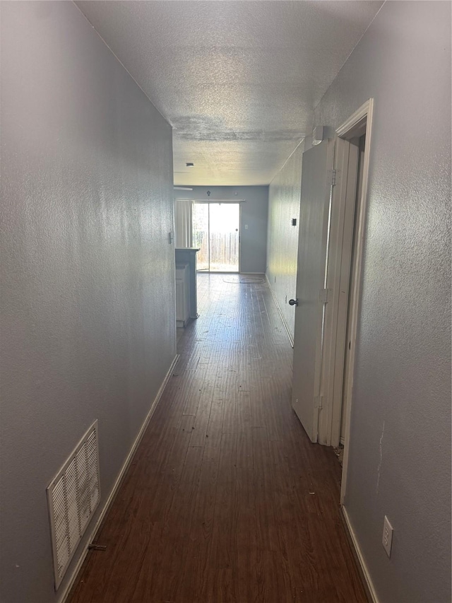 3048 Saint Ursula Dr, Dallas, TX 75233 - corridor with wood finished floors and a textured ceiling