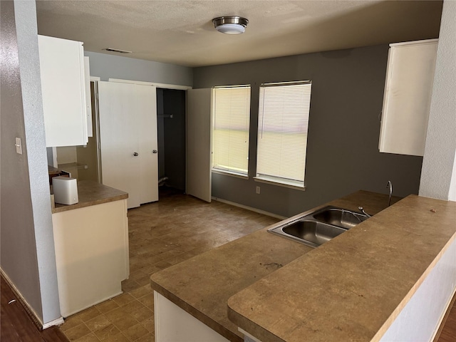 3048 Saint Ursula Dr, Dallas, TX 75233 - kitchen with white cabinetry and tile patterned floors