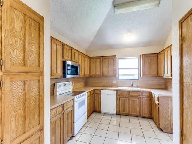 10200 Pack Saddle Ct, Fort Worth, TX 76108 - kitchen with white appliances, a textured ceiling, vaulted ceiling, light countertops, and light tile patterned flooring