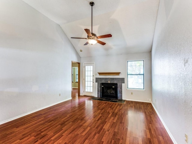 10200 Pack Saddle Ct, Fort Worth, TX 76108 - unfurnished living room featuring plenty of natural light, a ceiling fan, wood finished floors, a tiled fireplace, and high vaulted ceiling