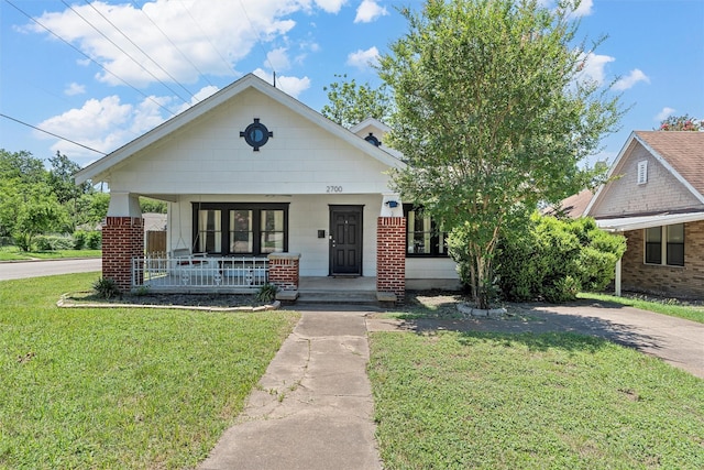 2700 Ethel Ave, Waco, TX 76707 - view of front facade with a porch, a front lawn, and brick siding