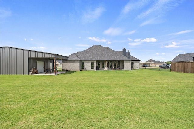 1005 Sinopa St, Caddo Mills, TX 75135 - back of house featuring a chimney and an outbuilding
