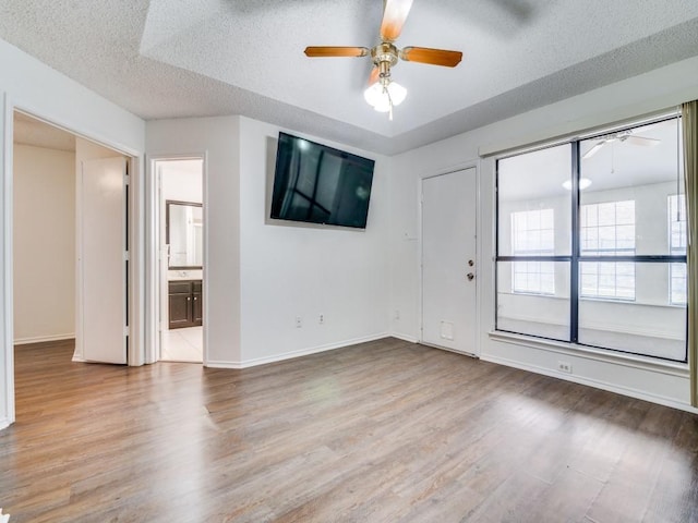 2705 Independence Dr, Mesquite, TX 75150 - unfurnished room featuring a ceiling fan, wood finished floors, and a textured ceiling