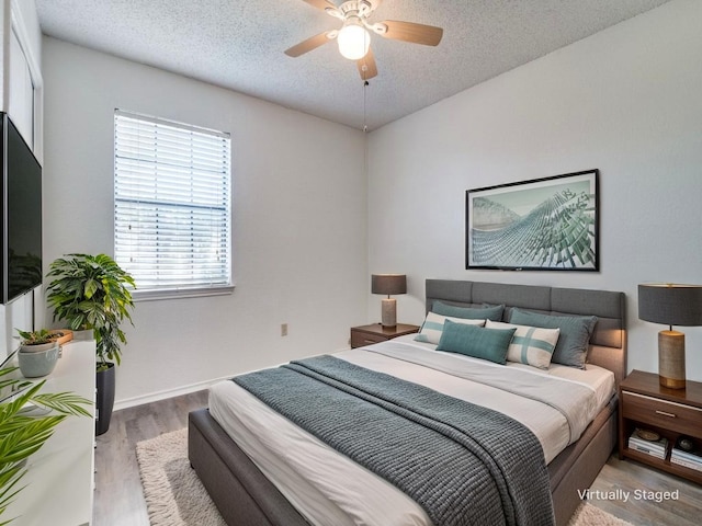 2705 Independence Dr, Mesquite, TX 75150 - bedroom with wood finished floors, a textured ceiling, and a ceiling fan