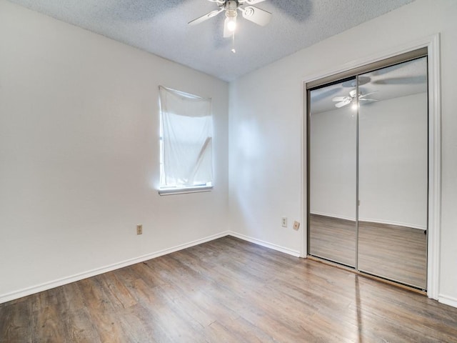 2705 Independence Dr, Mesquite, TX 75150 - unfurnished bedroom featuring wood finished floors, a textured ceiling, a closet, and ceiling fan