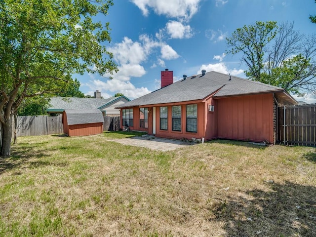 2705 Independence Dr, Mesquite, TX 75150 - back of property with a shed, a fenced backyard, board and batten siding, and a chimney