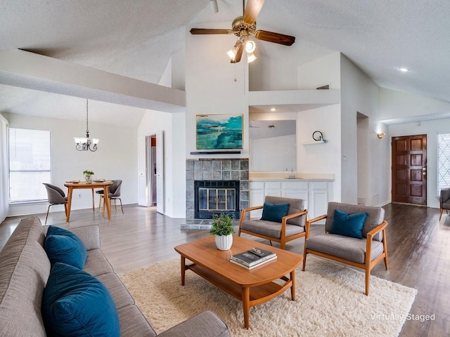 2705 Independence Dr, Mesquite, TX 75150 - living room with a chandelier, a tiled fireplace, ceiling fan, healthy amount of natural light, and high vaulted ceiling