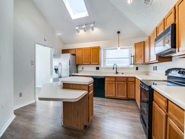 2705 Independence Dr, Mesquite, TX 75150 - kitchen featuring black appliances, lofted ceiling, a kitchen island, wood finished floors, and light countertops