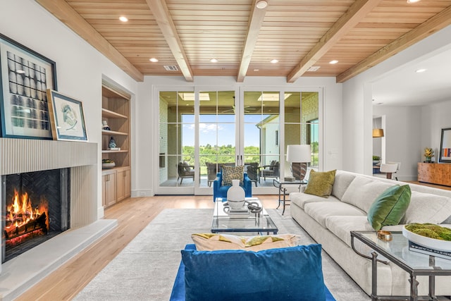 4532 Terroir Dr, Fort Worth, TX 76126 - living area with a lit fireplace, light wood-style flooring, recessed lighting, and a wooden ceiling with exposed beams