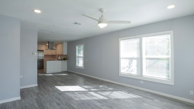1619 Baylor Ave, Waco, TX 76706 - unfurnished living room with wood finished floors, a ceiling fan, and recessed lighting