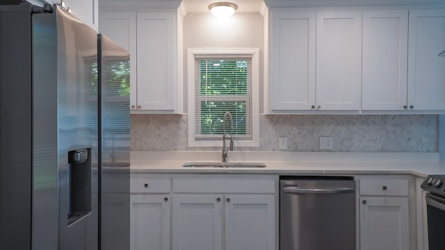 1619 Baylor Ave, Waco, TX 76706 - kitchen with appliances with stainless steel finishes, backsplash, white cabinetry, and light countertops