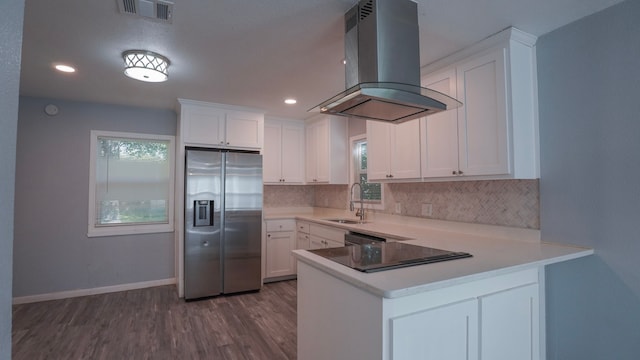 1619 Baylor Ave, Waco, TX 76706 - kitchen with appliances with stainless steel finishes, ventilation hood, decorative backsplash, a peninsula, and dark wood finished floors