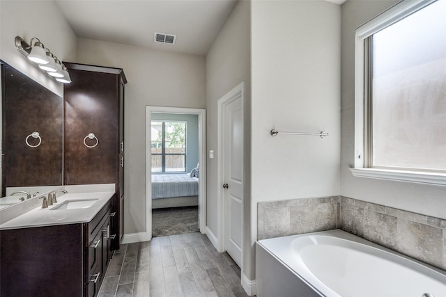6105 Horsetail Dr, Mckinney, TX 75071 - ensuite bathroom featuring vanity, wood finished floors, and a bath