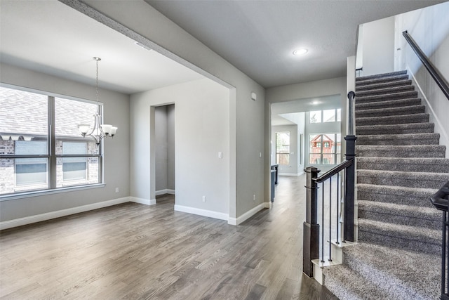 6105 Horsetail Dr, Mckinney, TX 75071 - stairs featuring a chandelier, wood finished floors, and recessed lighting