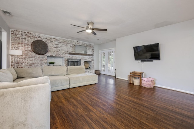 1203 Woodridge Cir, Euless, TX 76040 - living room featuring a ceiling fan, wood finished floors, a large fireplace, french doors, and brick wall