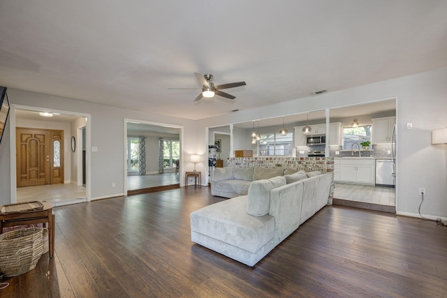 1203 Woodridge Cir, Euless, TX 76040 - living area featuring a ceiling fan and dark wood-style flooring