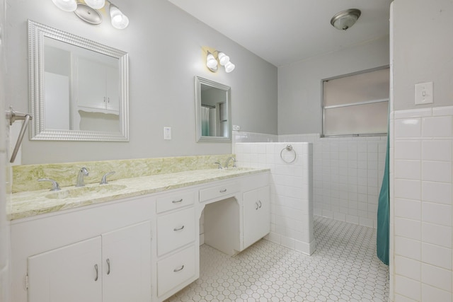 1203 Woodridge Cir, Euless, TX 76040 - bathroom featuring tile walls, a wainscoted wall, double vanity, and curtained shower