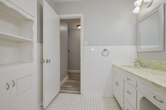 1203 Woodridge Cir, Euless, TX 76040 - bathroom featuring tile walls, vanity, a wainscoted wall, and tile patterned flooring