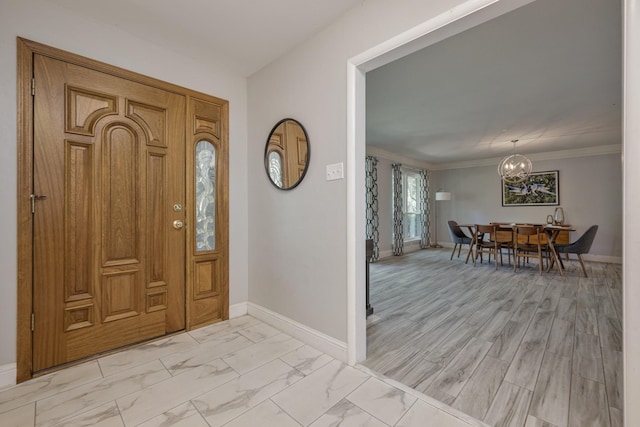1203 Woodridge Cir, Euless, TX 76040 - entrance foyer with a chandelier, light marble finish floors, and crown molding