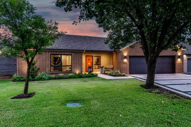 3866 Lively Ln, Dallas, TX 75220 - view of front of house featuring concrete driveway, an attached garage, a lawn, brick siding, and a shingled roof