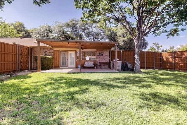 3302 Janwood Ln, Garland, TX 75044 - back of property featuring a fenced backyard, a patio, brick siding, and french doors