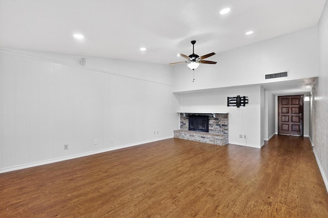3302 Janwood Ln, Garland, TX 75044 - unfurnished living room featuring wood finished floors, a ceiling fan, a brick fireplace, recessed lighting, and lofted ceiling
