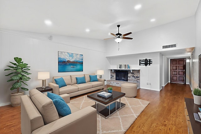 3302 Janwood Ln, Garland, TX 75044 - living area featuring a glass covered fireplace, wood finished floors, ceiling fan, recessed lighting, and vaulted ceiling