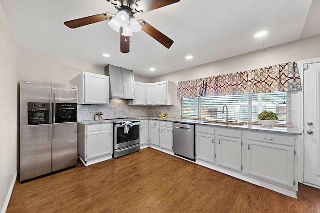 3302 Janwood Ln, Garland, TX 75044 - kitchen with stainless steel appliances, wall chimney range hood, dark wood finished floors, ceiling fan, and recessed lighting