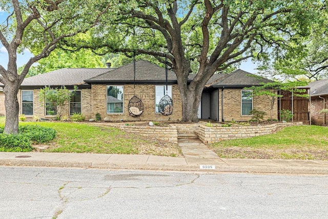 6005 Costera Ln, Dallas, TX 75248 - view of front of property featuring brick siding and a shingled roof