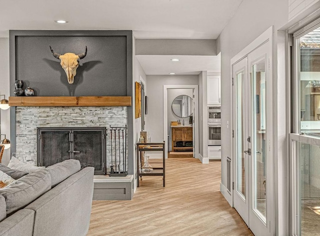 6005 Costera Ln, Dallas, TX 75248 - living room with light wood-type flooring, a fireplace, and recessed lighting