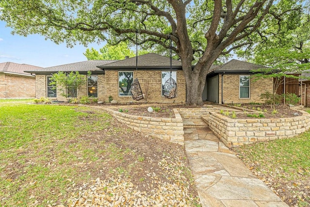 6005 Costera Ln, Dallas, TX 75248 - view of front of property featuring brick siding, a front yard, and a shingled roof