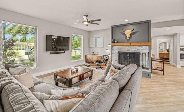 6005 Costera Ln, Dallas, TX 75248 - living area featuring plenty of natural light, a ceiling fan, a fireplace, light wood finished floors, and recessed lighting