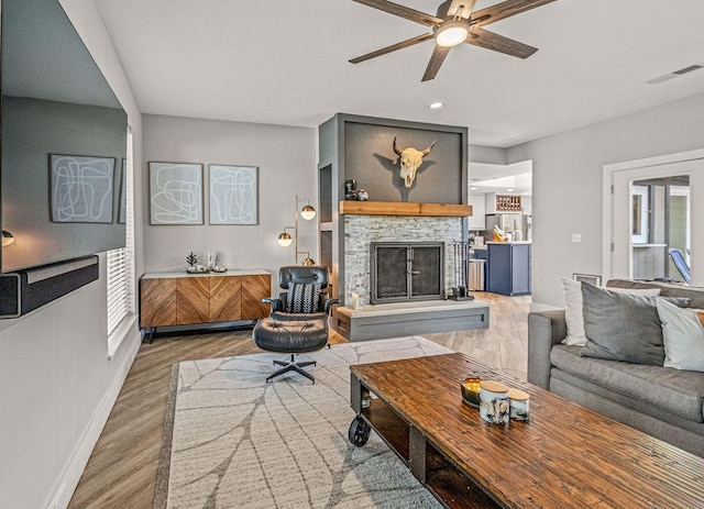 6005 Costera Ln, Dallas, TX 75248 - living room featuring a ceiling fan, a fireplace, wood finished floors, and recessed lighting