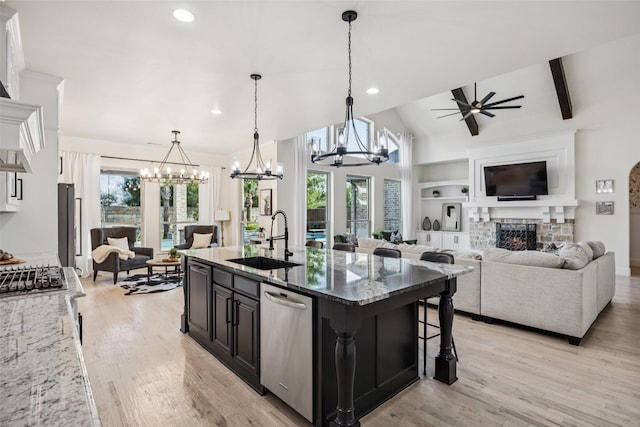 1030 Double B Trl, Prosper, TX 75078 - kitchen featuring stainless steel dishwasher, a chandelier, a ceiling fan, open floor plan, and light stone counters
