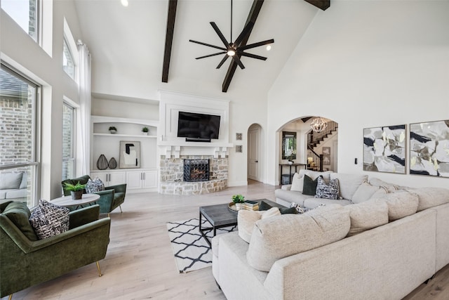 1030 Double B Trl, Prosper, TX 75078 - living room featuring high vaulted ceiling, stairs, arched walkways, ceiling fan, and beam ceiling