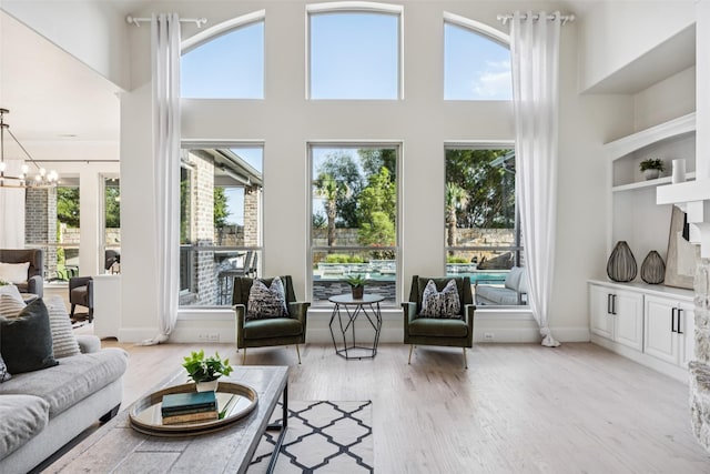 1030 Double B Trl, Prosper, TX 75078 - living area featuring a towering ceiling, a chandelier, and light wood-style floors