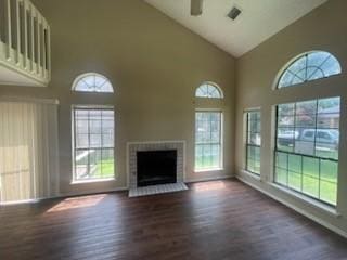 11805 Eloise Dr, Balch Springs, TX 75180 - unfurnished living room with high vaulted ceiling, plenty of natural light, dark wood-style floors, and a brick fireplace