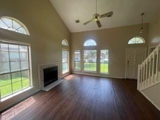 11805 Eloise Dr, Balch Springs, TX 75180 - unfurnished living room with high vaulted ceiling, a fireplace with raised hearth, healthy amount of natural light, a ceiling fan, and stairs