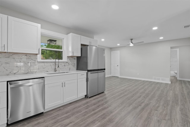 4118 Princeton Dr, Garland, TX 75042 - kitchen with stainless steel appliances, a ceiling fan, light countertops, recessed lighting, and tasteful backsplash