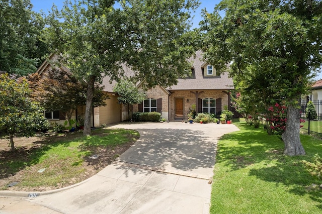 1911 Saddlehorn Ln, Mansfield, TX 76063 - obstructed view of property featuring brick siding, concrete driveway, and a shingled roof