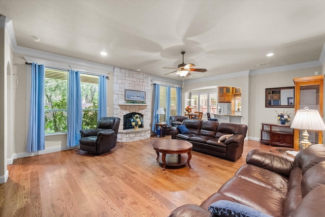 1911 Saddlehorn Ln, Mansfield, TX 76063 - living room featuring arched walkways, crown molding, ceiling fan, a fireplace, and wood finished floors