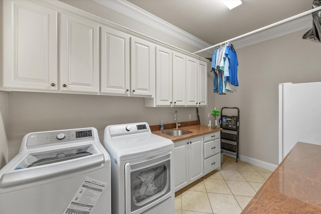 1911 Saddlehorn Ln, Mansfield, TX 76063 - washroom with washer and dryer, cabinet space, crown molding, and light tile patterned flooring
