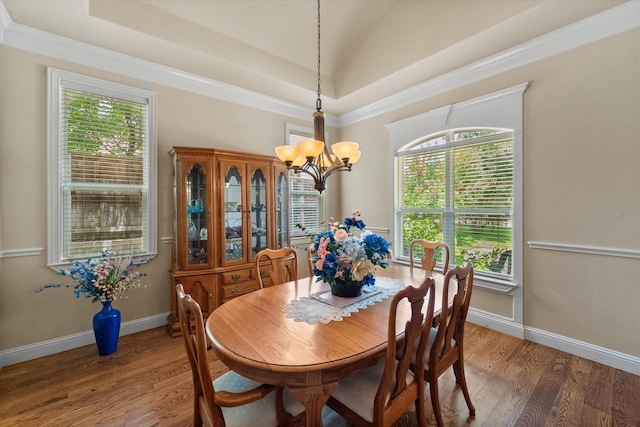 1911 Saddlehorn Ln, Mansfield, TX 76063 - dining space with a chandelier, wood finished floors, healthy amount of natural light, a raised ceiling, and crown molding