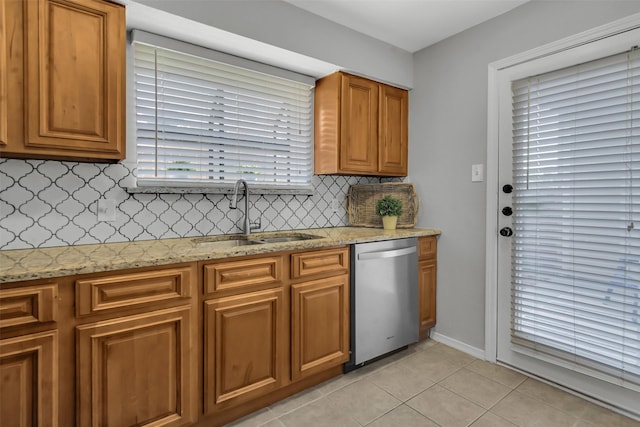 4748 Old Bent Tree Ln Unit 701, Dallas, TX 75287 - kitchen featuring stainless steel dishwasher, backsplash, light tile patterned floors, light stone countertops, and brown cabinets