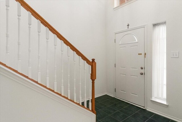 1100 Bellingham Pl, Arlington, TX 76001 - foyer featuring stairway and dark tile patterned floors