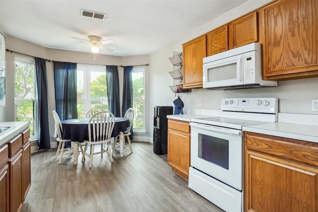 5905 Northfield Dr, Fort Worth, TX 76179 - kitchen featuring white appliances, ceiling fan, light countertops, and brown cabinetry