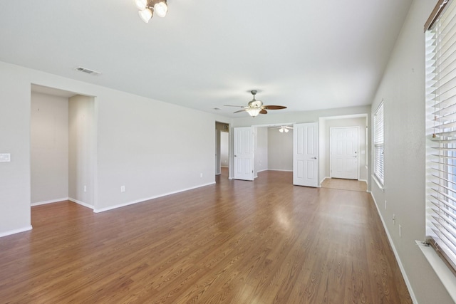 7850 Estancia Dr, Frisco, TX 75036 - unfurnished living room with wood finished floors and ceiling fan