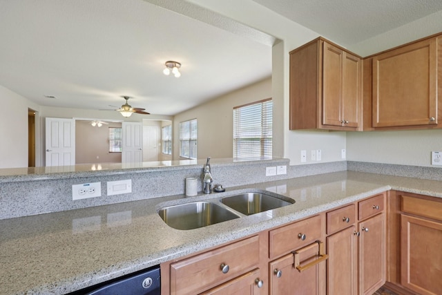 7850 Estancia Dr, Frisco, TX 75036 - kitchen featuring light stone countertops, a ceiling fan, brown cabinets, and dishwasher